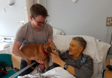 Trevor receiving a visit from his dog in the Inpatient Unit