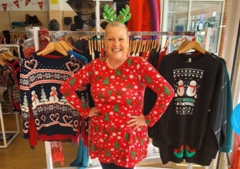 A lady who works at St Barnabas as a Shop Manager at our Birchwood shop, wearing a Christmas jumper