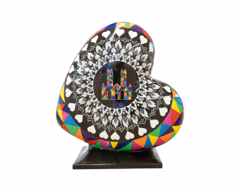 A Heart-shaped sculpture, painted with a colourful mandella design, whilst featuring Lincoln Cathedral in the middle. This sculpture is part of the St Barnabas HeART Trail.