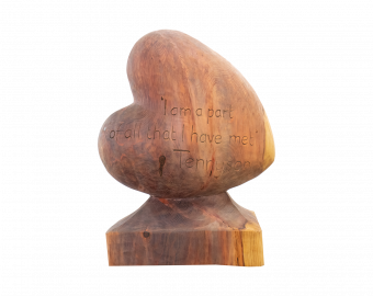 A Heart-shaped sculpture, carved out of Redwood. The words 'I am a part of all that I have met' a quote by Lincolnshire poet, Alfred Tennyson. This sculpture is part of the St Barnabas HeART Trail.