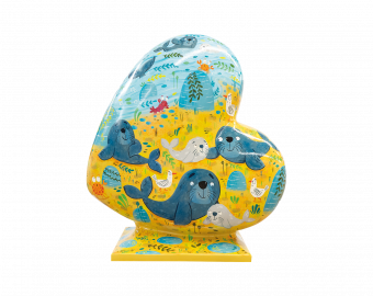 A Heart-shaped sculpture, illustrated with blue seals on a yellow and blue backgound, symbolising Donna Nook in Lincolnshire. This sculpture is part of the St Barnabas HeART Trail.