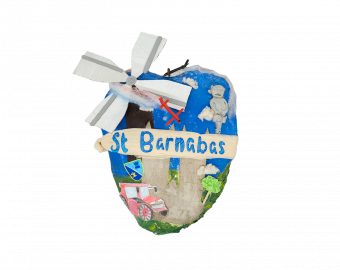 A Heart shaped sculpture, created by school children. The Heart depicts key points of interest, such as Lincoln Cathedral, the Imp, Windmills and Tractors, in the setting of a sunny day. Going across the Heart reads 'St Barnabas'.