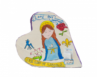 A Heart shaped sculpture, created by school children. The Heart depicts Mary, who takes care of St Barnabas Patients. Underneath Mary is a box containing leaflets, with prayers or quotes written on them.