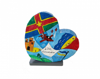 A Heart shaped sculpture, created by school children. The Heart depicts activities and places of interest that the Children of Sir Francis Hill Primary School enjoy to do and see.