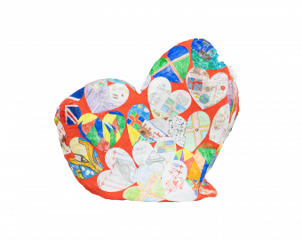 A Heart shaped sculpture, created by school children. The Heart is painted red, with dozens smaller hearts on top, each with designed created by the children, with the theme of 'Love Lincolnshire. Some hearts include flowers, to famous landmarks.