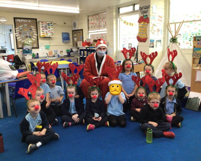 Classroom of children with antlers and Santa Clause