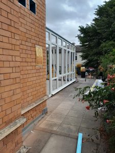 Exterior of brick building with white gating.