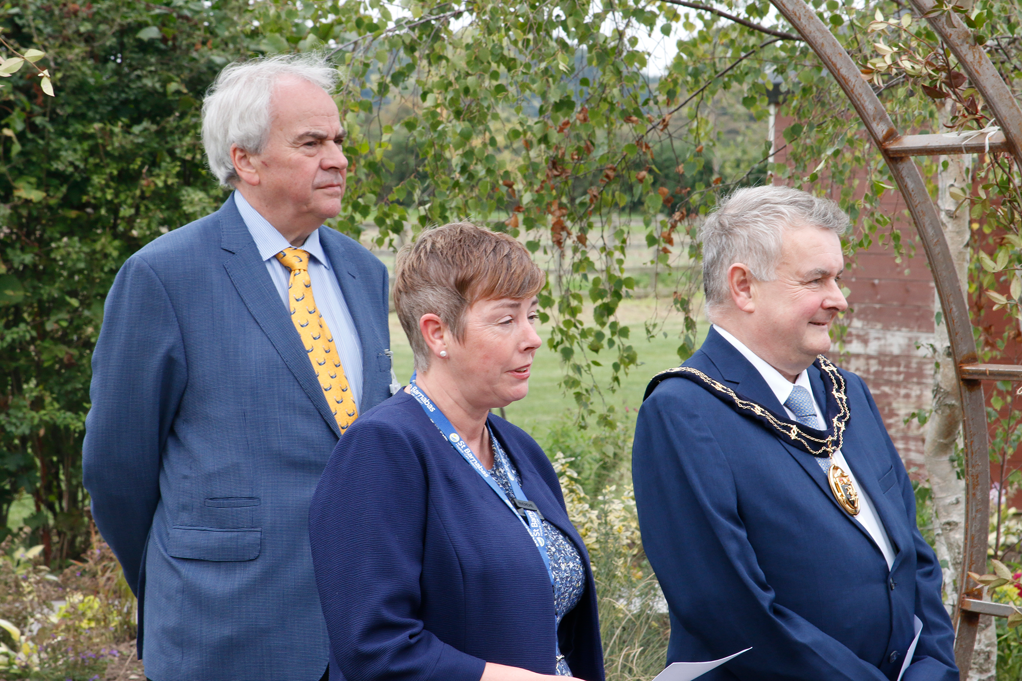 Woman and two men wearing formal attire at reopening of Louth Wellbeing Centre