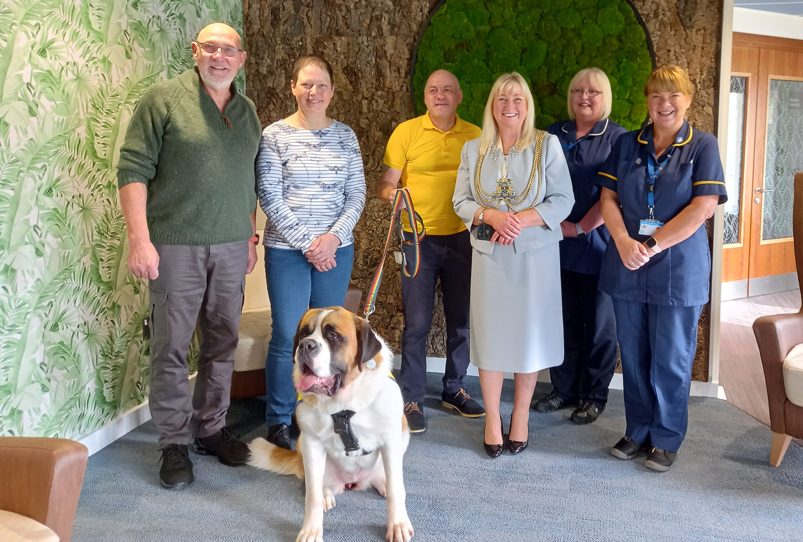 Group of men and women with a St Bernard Dog