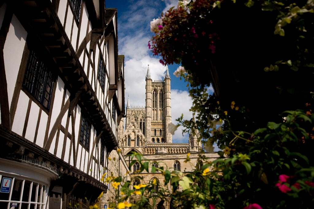 A view of the Cathedral from Castle Square, Lincoln, with Tudor building and trees in foreground