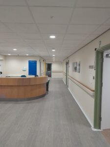 Reception area with large white wall corridor