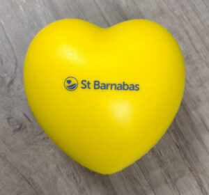 Yellow heart with St Barnabas logo in middle