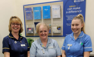 Three women in blue medical scrubs