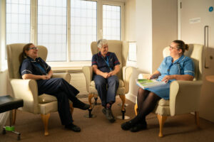 Three members of the St Barnabas Hospice Clinical team, sat inside our Barrowby Road Wellbeing centre in Grantham