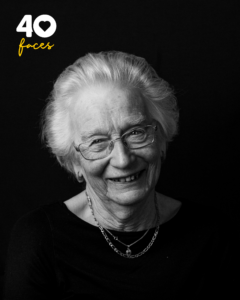 A lady, Barbara Jones, who is a volunteer at St Barnabas Hospice, photographed in black and white, against a black backdrop
