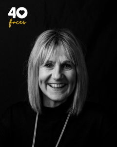 A lady, Julie Fisher, who is a supporter of St Barnabas Hospice, photographed in black and white, against a black backdrop
