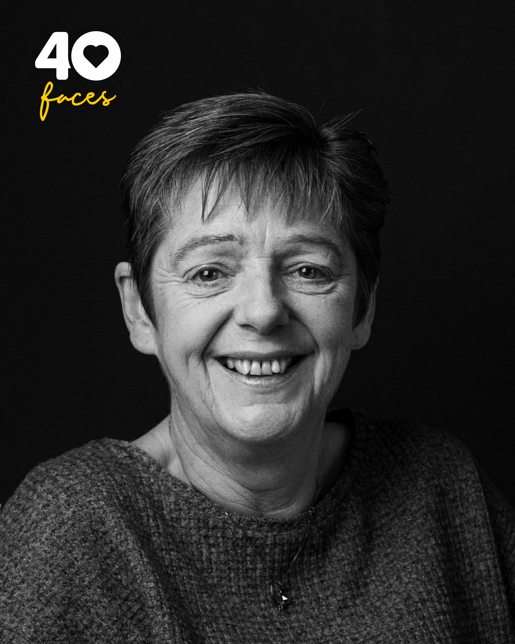 A lady, Marie Pattison, who is a Supporter Care Officer at St Barnabas Hospice, photographed in black and white, against a black backdrop