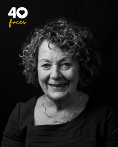 A lady, Sue Glaister, who is a former trustee of St Barnabas Hospice, photographed in black and white, against a black backdrop
