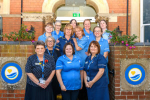 Clinical staff including nurses in blue uniforms stood outside our Lincoln Inpatient Unit.