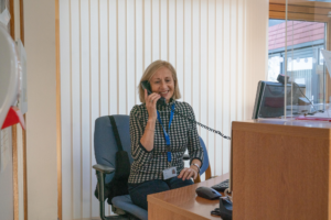 Blonde woman on the phone at receptionist desk