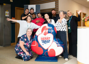 A group of people who work at HomeLet Lincoln, standing around the flagship HeART for the upcoming St Barnabas HeART Trail.
