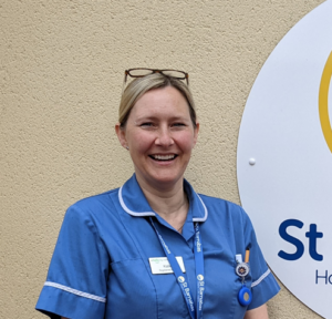 A woman, one of the St Barnabas Staff Nurses, wearing a blue tunic, stood outside the St Barnabas Wellbeing Centre in Louth.