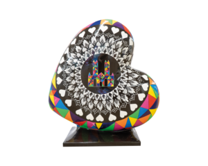 A Heart-shaped sculpture, painted with a colourful mandella design, whilst featuring Lincoln Cathedral in the middle. This sculpture is part of the St Barnabas HeART Trail.