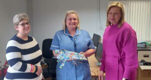 Three women, on the last Trish Wright wearing a black and white striped top, in the middle Emma Rogers wearing blue nurse uniform and on the right Amanda Last, wearing a pink outfit.