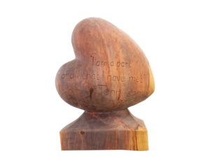 A Heart-shaped sculpture, carved out of Redwood. The words 'I am a part of all that I have met' a quote by Lincolnshire poet, Alfred Tennyson. This sculpture is part of the St Barnabas HeART Trail.