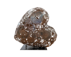 A Heart-shaped sculpture, created out of welded metal cogs and gears. This sculpture is part of the St Barnabas HeART Trail.
