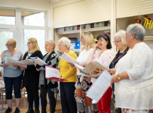 Group of women standing and holding folders at the St Barnabas Wellbeing Centre in Louth.