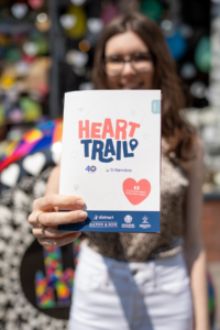 Young woman in background with focus on HeART Trail guide in her hand
