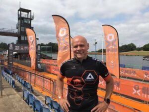 A man, wearing an all black sports top, at the finishing line at the Outlaw Triathlon event.