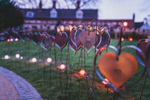 Iron work hearts planted into grass with lights outside Lincoln Cathedral