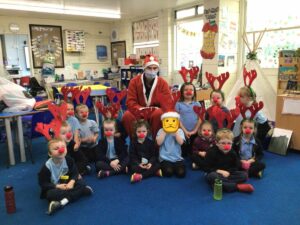 Classroom of children with antlers and Santa Clause