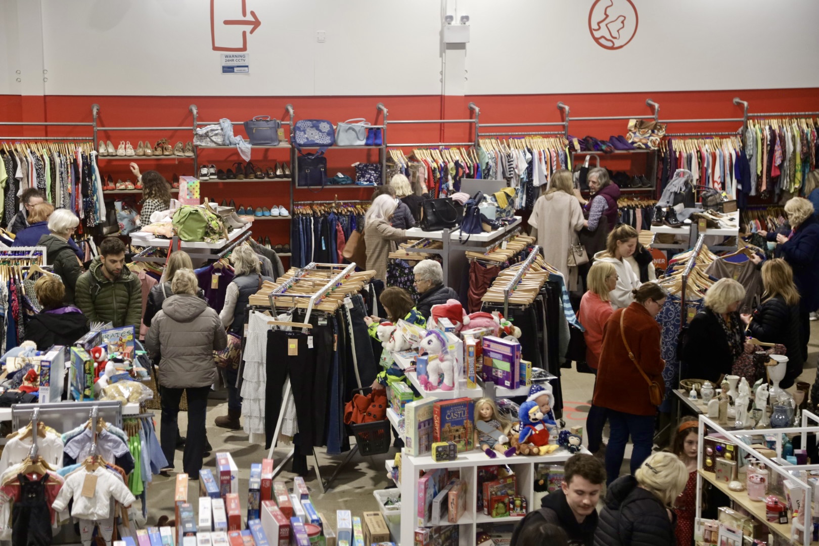 Warehouse shop floor with shoppers browsing clothes and items