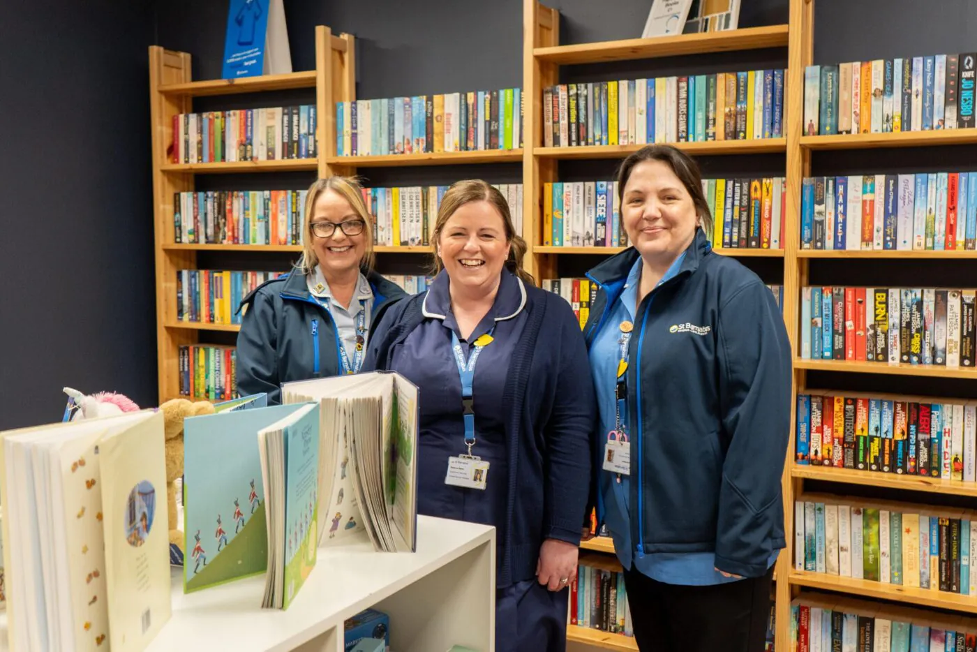 Three nurses in front of the Boston Charity Shop